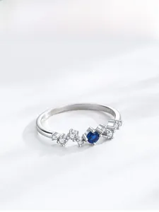 Detailed close-up of S925 sterling silver wave ring with blue sapphire and white zircons