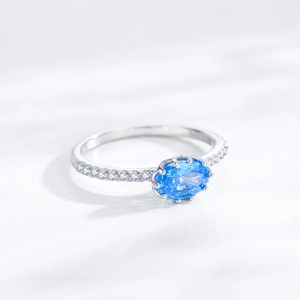 Minimalist S925 sterling silver ring with oval blue zircon and small side diamonds