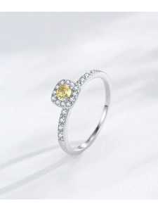 Macro detail of S925 silver ring featuring a halo-set square yellow cubic zirconia stone