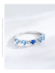 Macro view of S925 silver ring featuring blue gradient heart-shaped gemstones