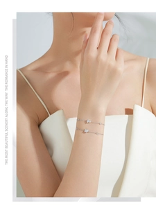 Close-up of minimalist S925 silver adjustable bracelets with clear zircon gemstones on wrist