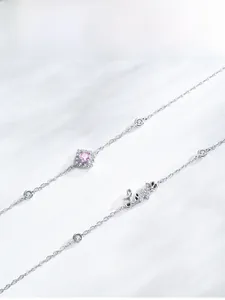 Detail of S925 silver bracelet featuring pink gemstone pendant and Love script letter