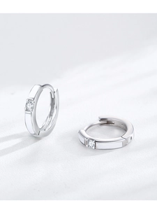 Detailed macro view of S925 silver hoop earrings with white enamel and cubic zirconia