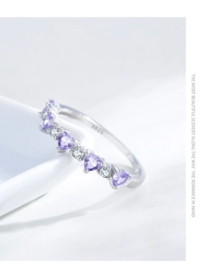Macro shot of S925 sterling silver ring with purple heart-shaped cubic zirconia and hallmark