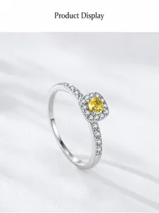 Macro view of S925 silver ring featuring a round yellow gemstone with pavé zircon accents