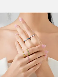Model wearing a stackable set of S925 silver rings with colorful enamel and micro-diamonds