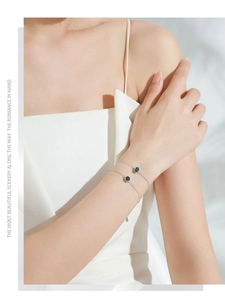 Close-up of elegant S925 silver bracelets with green and blue rectangular zircon gems