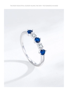 Detail of S925 silver ring featuring alternating blue and white zircon gemstones