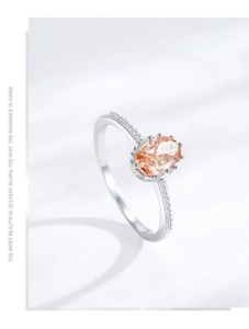 Detailed macro of a silver ring with an oval orange stone and beaded edge craftsmanship