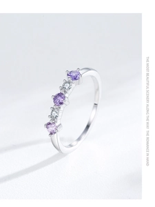 Detail of S925 sterling silver ring featuring purple and white zircon stones in 4-prong setting
