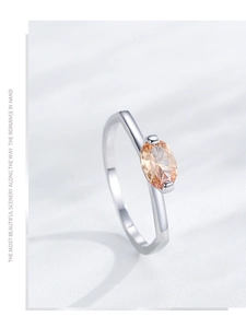 Macro shot of an oval champagne gemstone set in polished S925 sterling silver ring