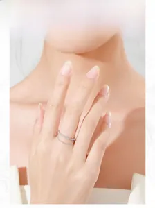 Detailed view of a layered S925 sterling silver chain ring with cubic zirconia on a model