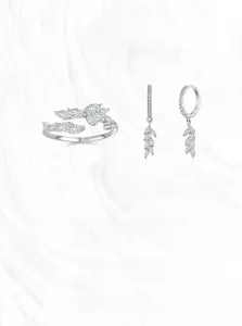 Macro shot of S925 silver leaf ring and earrings set with marquise-cut zircons