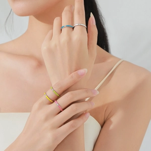 Set of 5 colorful enamel S925 silver rings with small zircons on a model's hand