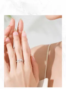 Model wearing a S925 sterling silver leaf ring with marquise-cut white zircons