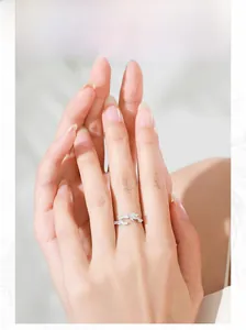 Detail of S925 sterling silver leaf ring with pavé diamonds worn on finger