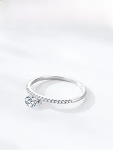 Detail shot of S925 sterling silver ring featuring a dangling round cut diamond charm