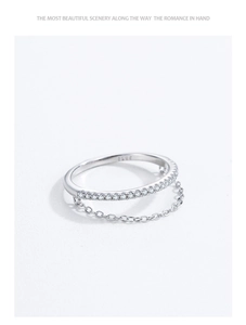 Macro detail of S925 sterling silver ring featuring zircon pave and hanging chain