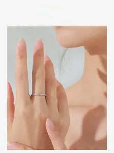 Detail of S925 sterling silver twisted ring featuring delicate zircon stones on finger