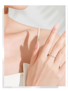 Detail of S925 silver interwoven ring with micro-pave diamonds on model finger