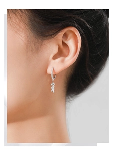 Close-up of S925 sterling silver leaf hoop earrings with cubic zirconia on a model