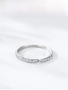 Macro detail of S925 sterling silver twisted ring with shimmering zircon stones