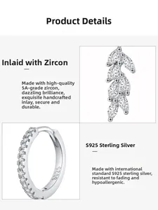 Macro detail of S925 sterling silver hoop earrings with sparkling leaf zircon pendants