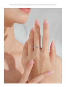 Close-up of S925 sterling silver wave ring with pavé stones on a model's finger