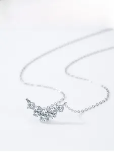 Macro shot of S925 silver necklace with five sparkling zircon stones in prong setting