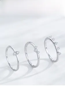 Macro view of three S925 sterling silver rings with delicate white zircon stone settings