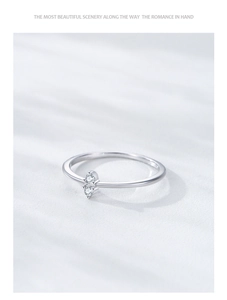 Macro detail of minimalist S925 sterling silver ring with two vertical zircon stones