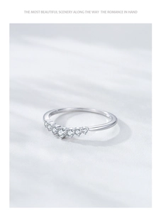 Macro detail of silver S925 wishbone ring with seven sparkling white zircons