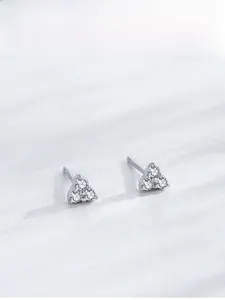 Macro detail of S925 sterling silver triangle stud earrings with three zircon stones