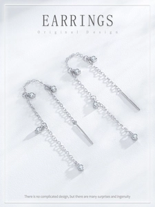 Detail view of long S925 sterling silver tassel earrings with four round cubic zirconia stones