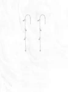 Detailed macro view of S925 sterling silver tassel earrings with round cubic zirconia stones