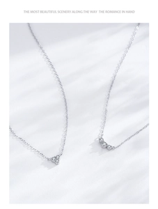 Detail of silver S925 geometric triangle necklaces with fine zircon accents in leaf light