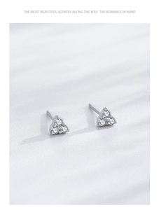 Macro shot of S925 sterling silver stud earrings with three sparkling round zircons