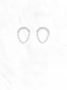 Detail of S925 silver chain drop earrings with micro-pave crystals on a marble base