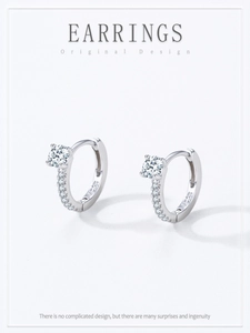 Macro detail of S925 sterling silver hoop earrings with clear round cubic zirconia