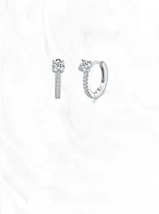 Macro shot of S925 sterling silver hoop earrings with round zircon and hallmark engraving