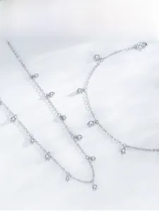 Detailed view of silver S925 bracelet with dangling round zircon stones on silk