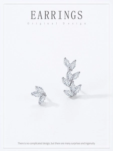 Detail of asymmetric S925 sterling silver leaf earrings with marquise-cut zircons