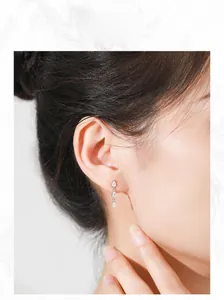 Close-up of S925 silver water drop earrings with sparkling cubic zirconia on model