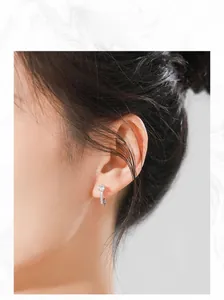 Detailed view of model wearing minimalist S925 silver hoop earrings with round zircon