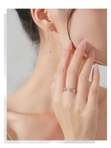 Close-up of S925 sterling silver chain ring with three sparkling zircon charms on a finger