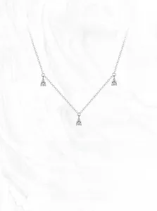 Macro detail of S925 sterling silver chain with three sparkling teardrop zircon pendants