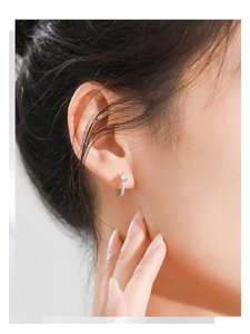 Close-up of S925 sterling silver hoop earrings with pavé cubic zirconia on the earlobe
