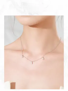 Close-up of S925 sterling silver necklace with three drop-shaped zircon pendants on model
