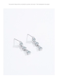Macro detail of S925 sterling silver earrings with triple teardrop cubic zirconia stones