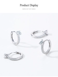 Détail macro de boucles d'oreilles créoles en argent S925 avec zircons goutte